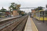 A view east along platform 3 at Huyton with work continuing to reinstate platform 4 on the left. During the first week of the Liverpool Lime Street closure (starting on 30 September) commissioning of the 4th track and platform is scheduled to take place now that extra land has been obtained next to the building on the left in the background.<br><br>[John McIntyre 26/09/2017]