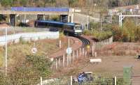ScotRail 170395 has just cleared Whitehill Road Bridge shortly after restarting from Newcraighall station on 5 November 2017. The 1011 Edinburgh Waverley - Tweedbank is about to run onto the double track section at Newcraighall South Junction.<br><br>[John Furnevel 05/11/2017]