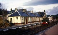 The main station building at Boat of Garten in late December 1975 with the 4w DM Motor Rail (ex Aberdeen Gas Works No.1D) sat in Platform 1. Reconstruction of the footbridge had just started as can be seen on the left with the appearance of the first 'tower'.<br><br>[John McIntyre 30/12/1975]