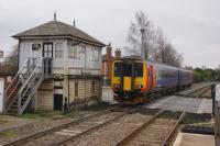 An EMT service to Nottingham has just departed Newark Castle station as it passes the signalbox and LC on 18 February 2018.<br><br>[John McIntyre 18/02/2018]