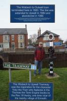 There is very little to see of the former Wisbech and Upwell Tramway which finally closed in 1966. Beside the canal at Outwell where the tramway had a small yard, local historian and author Mr William Smith stands beside a monument he designed and had erected so that the tramway is not forgotten. The top of the monument is an old signpost which had been found buried after it had been taken down during WW2. The arms of the signpost have been adapted to include some facts about the tramway. The rest of the construction includes a trolley wheel, a piece of 80 lb/yd bullhead rail sat in a chair and attached to a short length of sleeper. The lower part of the post has been adorned with views of the tramway when it was working. Note the connection to Toby the Tram engine!<br>
<br><br>[John McIntyre 21/02/2018]