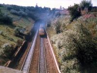 A DMU bursts smokely out of Cowlairs tunnel. The line here was crossed by a freight branch of the Caley now closed and removed.<br><br>[Ewan Crawford //1987]