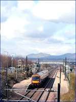 Clouds forming over the Pentland Hills in April 2006 as an Edinburgh bound service from North Berwick pulls into Wallyford station.<br><br>[John Furnevel /04/2006]