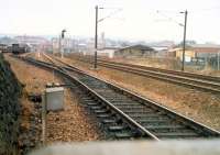 Just south of Strathclyde Junction is this view looking south to Rutherglen. The yard on the left is Bridgeton Yard for the Civil Engineer. The line to the right is the low level Glasgow Central line. Beyond that is the railway training school.<br><br>[Ewan Crawford //1988]