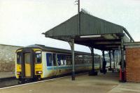 Westbound Sprinter entering Forres. The canopy is part of the old station building. This station opened with the line to Perth and replaced another station well beyond the station wall on the left.<br><br>[Ewan Crawford //]