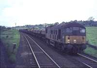 A Derby Diesel with a down freight at Busby Junction on 16 May 1964. Photographed from an East Kilbride train crossing in front of the freight.<br><br>[John Robin 16/05/1964]