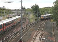 A diverted Queen Street - Waverley service about to come off the sub at Portobello on 9 July 2006, just as a GNER train for Kings Cross passes southbound on the ECML.<br><br>[John Furnevel 09/07/2006]